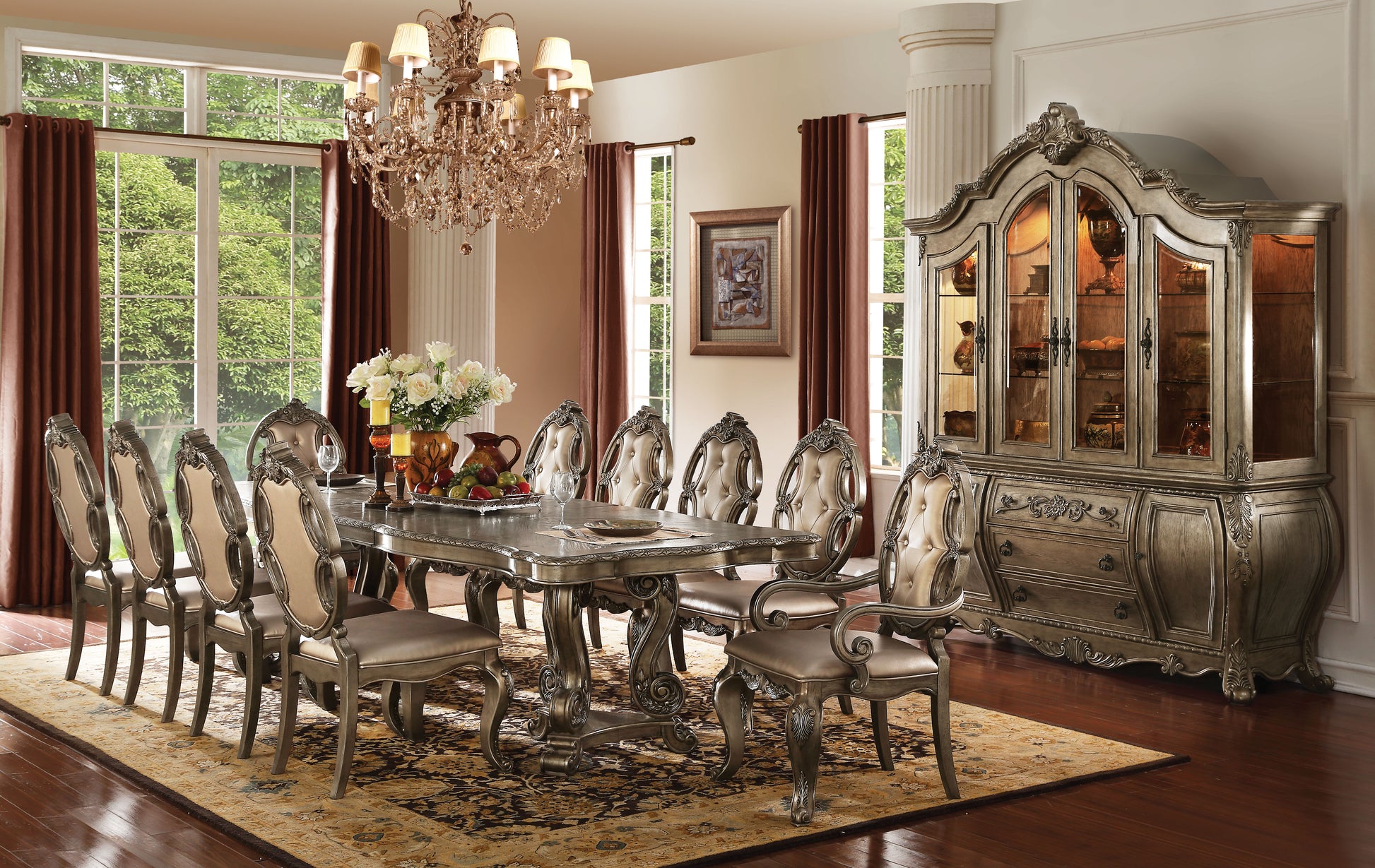 Ornate antique dining table with carved wooden legs and upholstered chairs