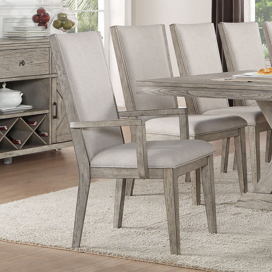 Light gray upholstered arm chair with distressed wood frame perfect for dining rooms