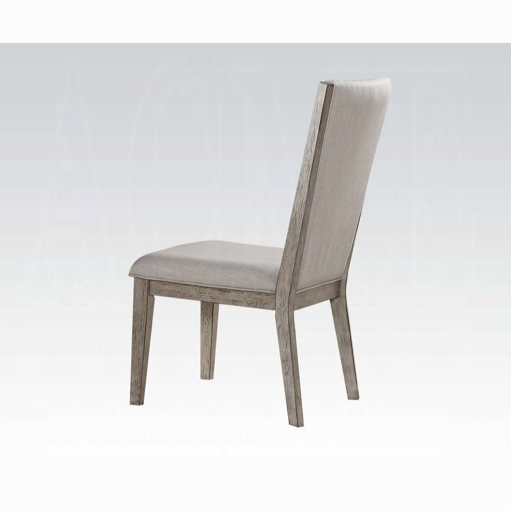 Upholstered dining chair with light grey fabric and weathered wood frame seen from the back