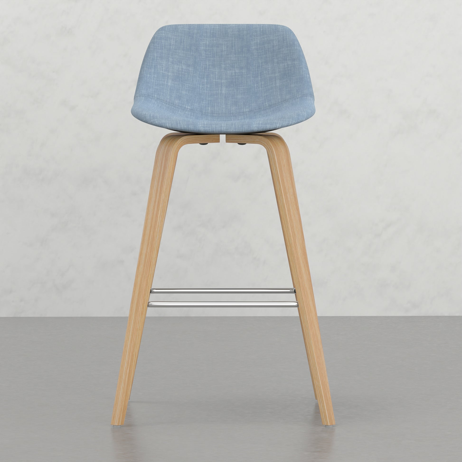 Light blue fabric upholstered bar stool with natural wood legs and metal footrest