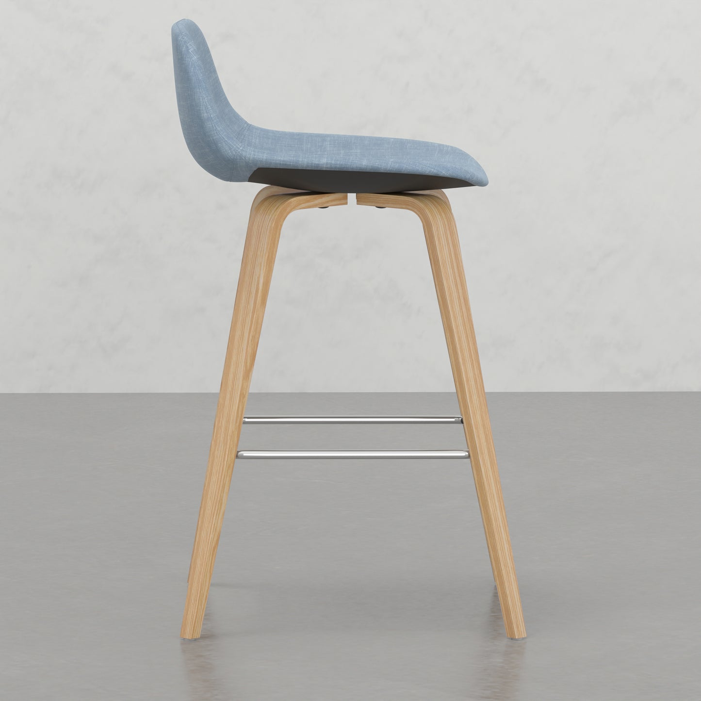 Light blue upholstered bar stool with natural wood legs and chrome footrest