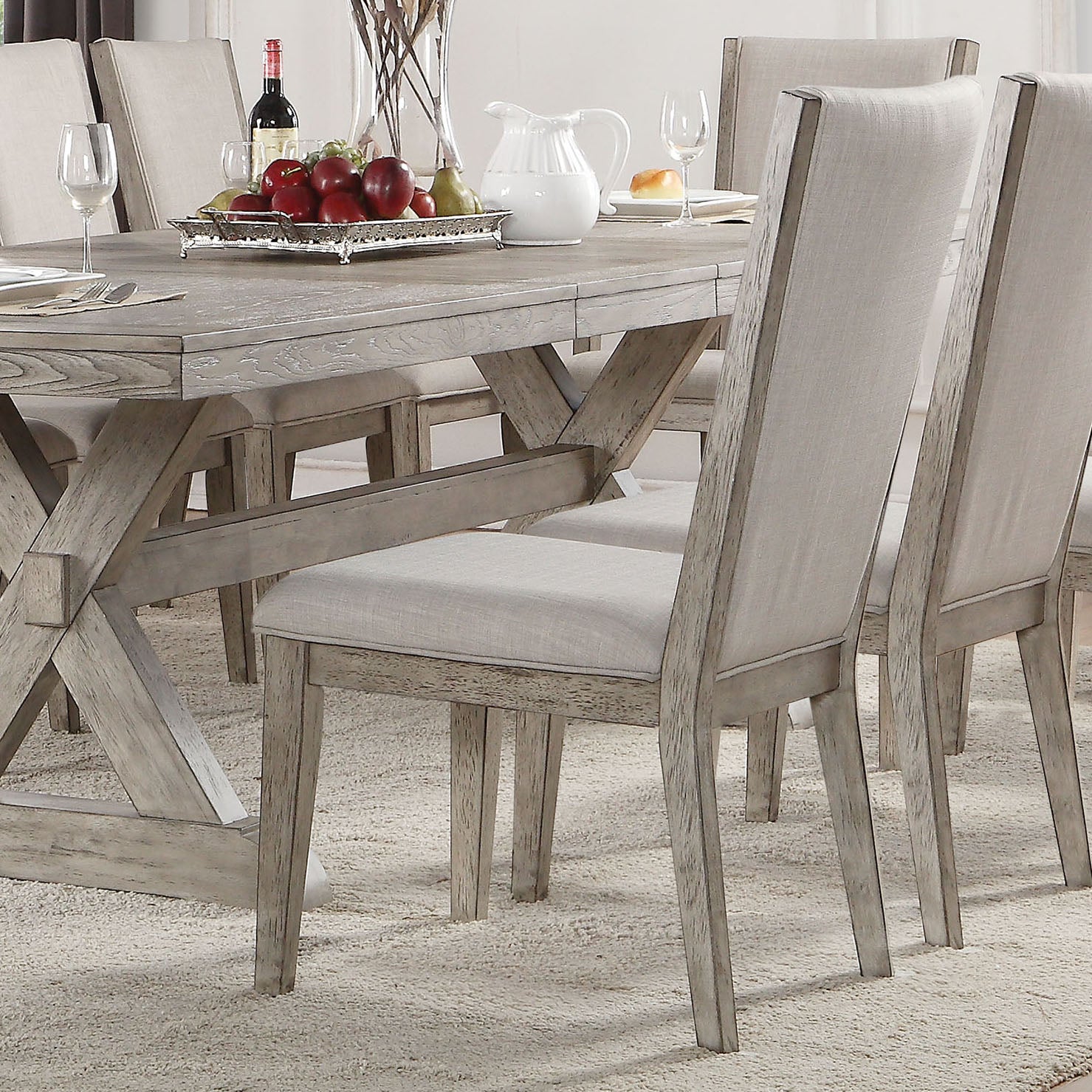 Distressed grey wood dining table with crossleg base set for a meal