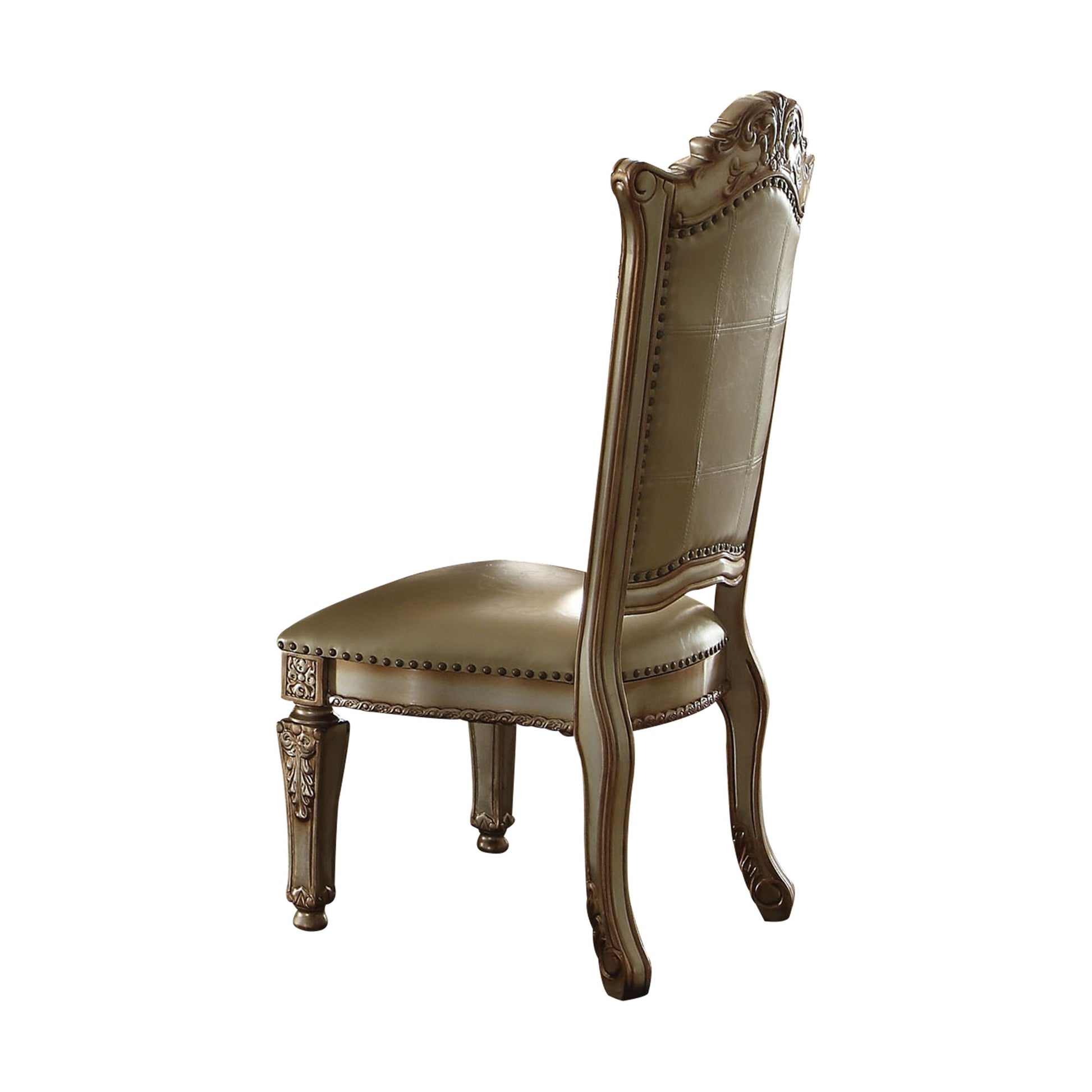 Antique gold upholstered dining chair with ornate carved wood details and brass nailhead trim