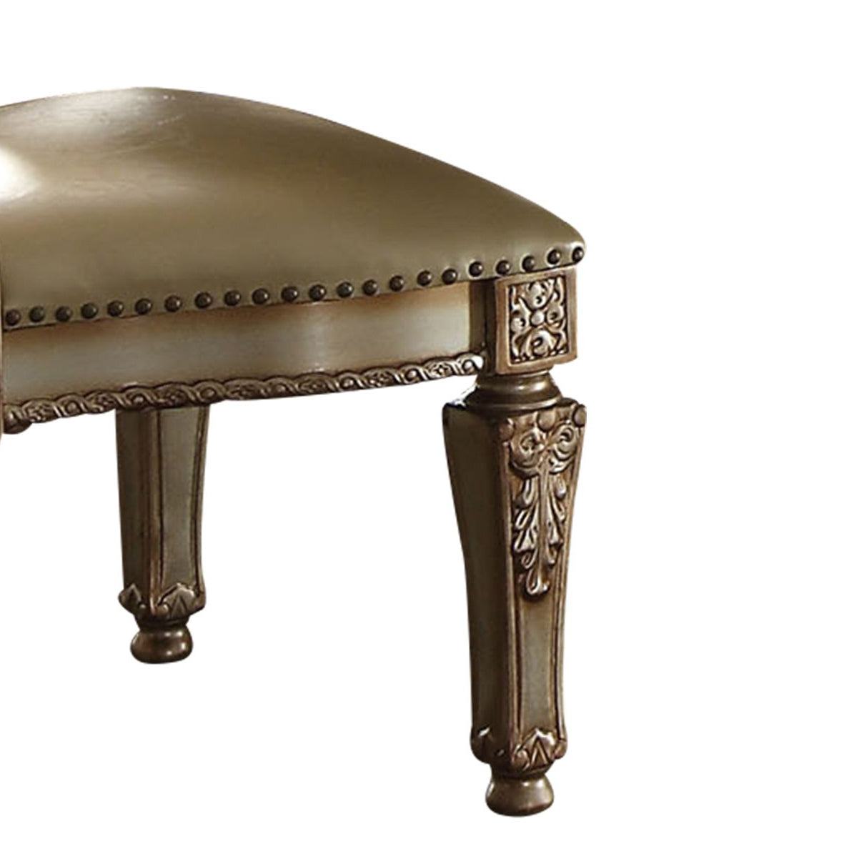 Antique cream upholstered ottoman with nailhead trim and carved legs