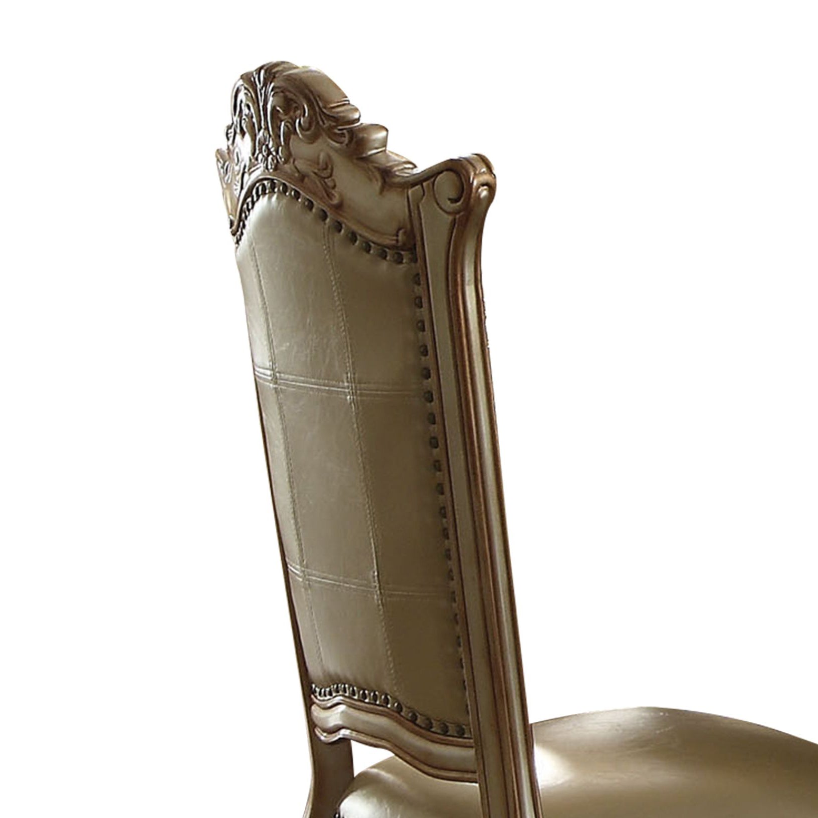 Elegant tan leather dining chair with ornate carved wooden frame and brass nailhead trim