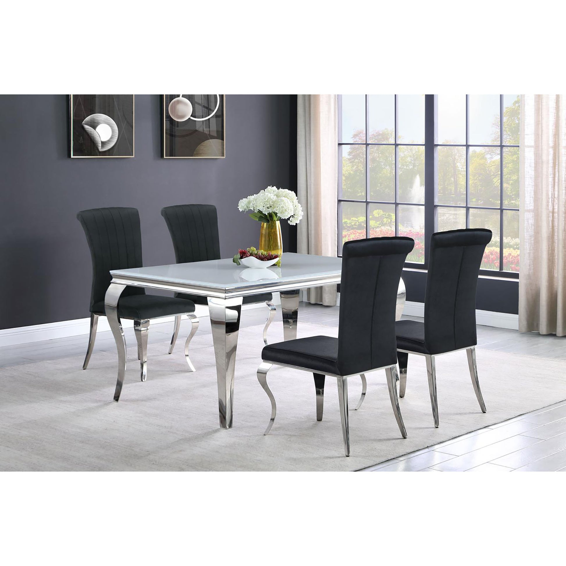 Modern dining set with a white glass top table and four black velvet chairs with chrome legs