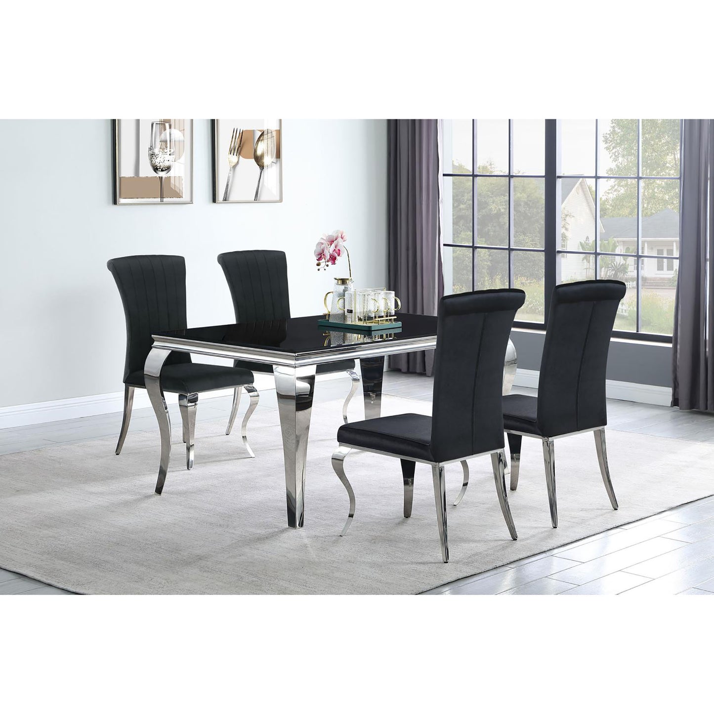 Black velvet dining chairs with chrome legs surrounding a sleek black glass dining table