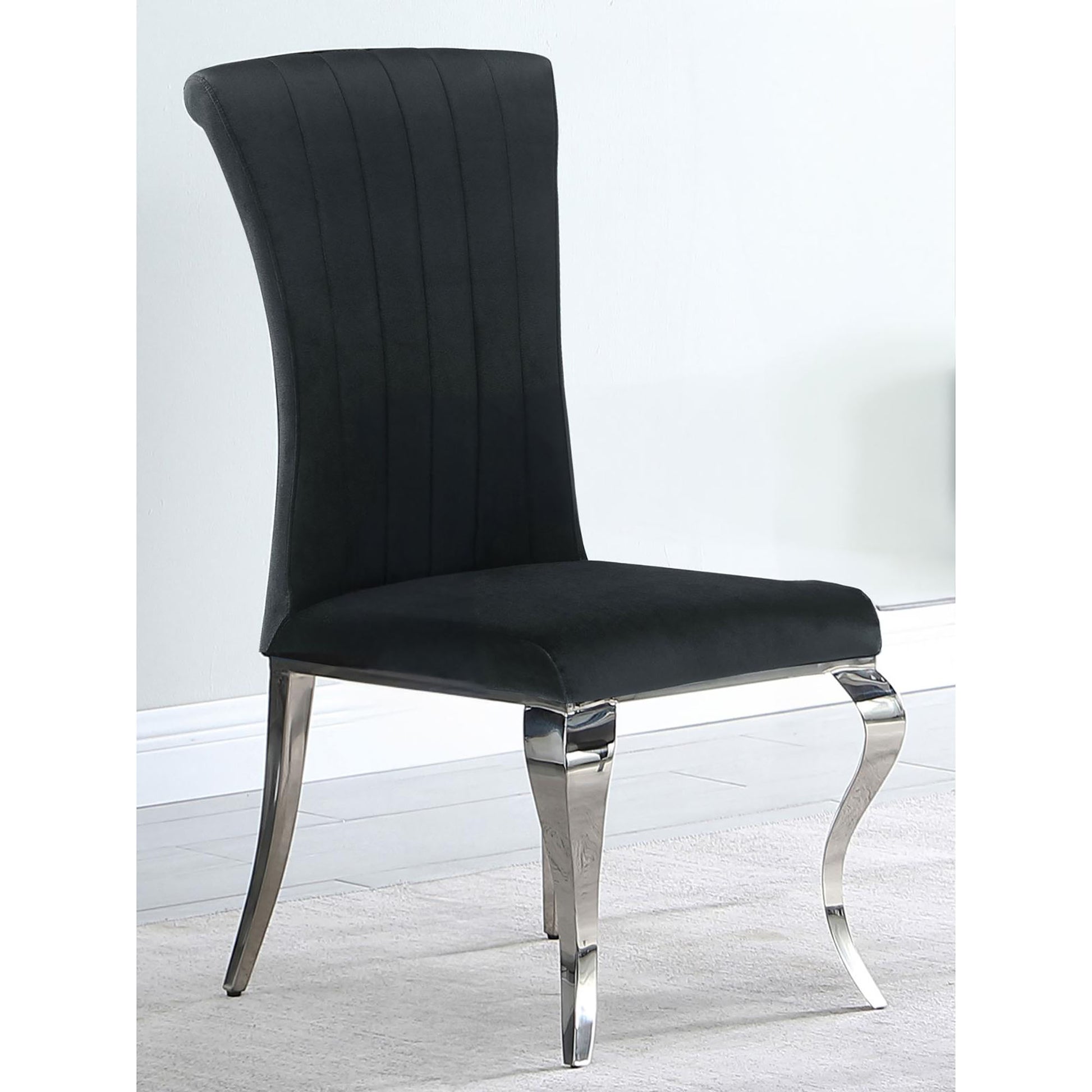 Elegant black velvet dining chair with chrome legs and vertical channel tufting for modern appeal