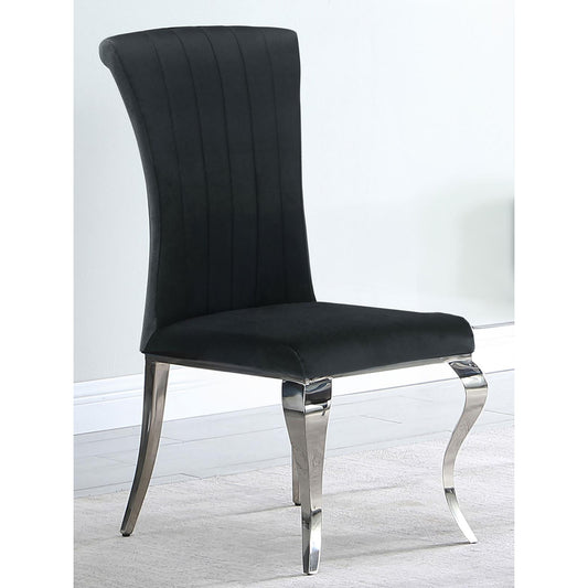 Elegant black velvet dining chair with chrome legs and vertical channel tufting for modern appeal