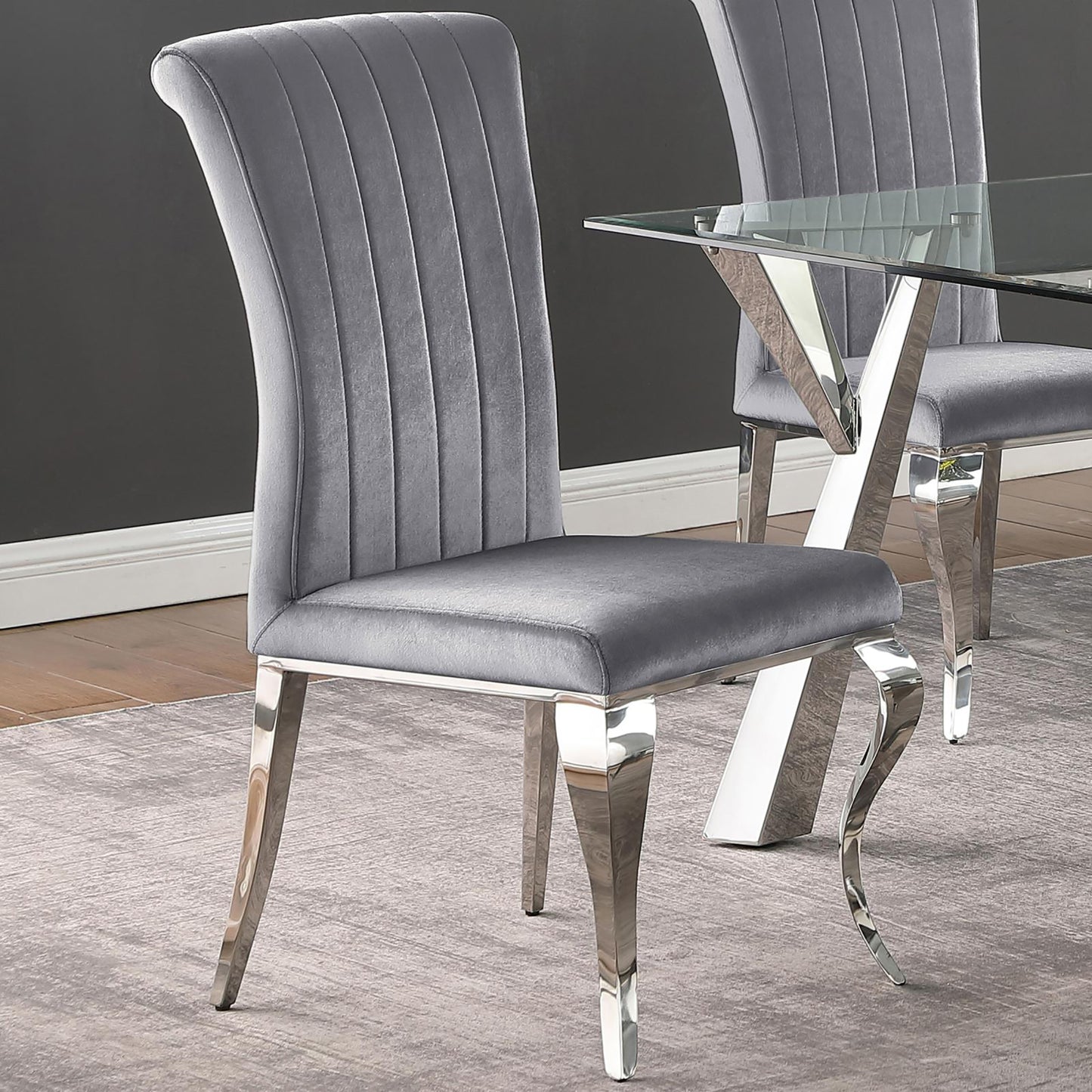 Plush grey velvet dining chair with channel tufting and polished chrome legs