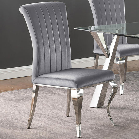 Plush grey velvet dining chair with channel tufting and polished chrome legs