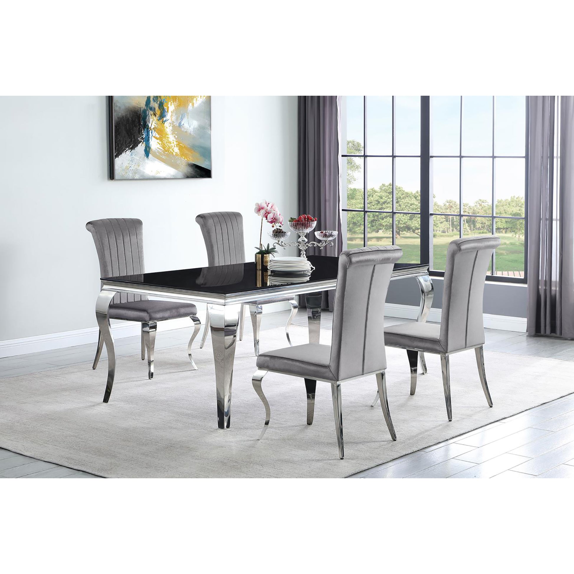 Modern dining set with black glass table and four grey velvet chairs with chrome legs