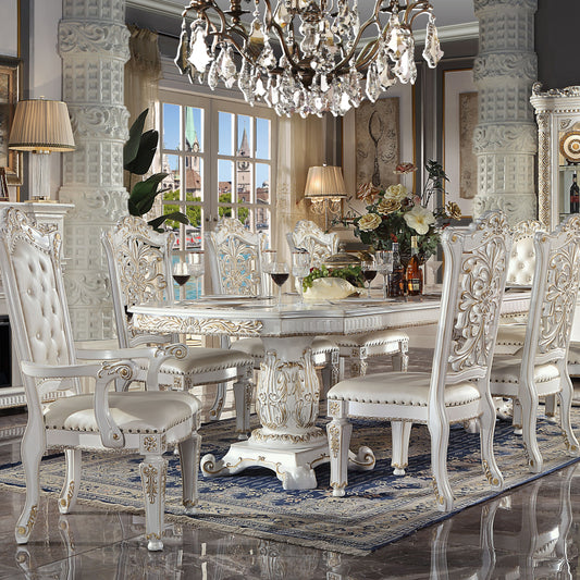 Elegant white tufted dining chair with gold accents and ornate carvings part of a formal dining set