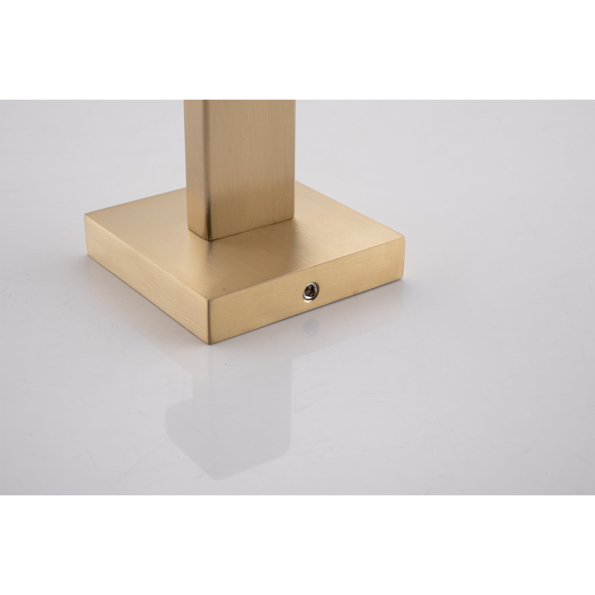 Brushed brass metal lamp base with square silhouette and screw detail