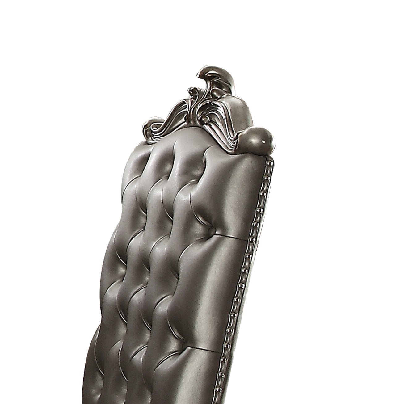 Tufted grey faux leather dining chair with nailhead trim and ornate top detail