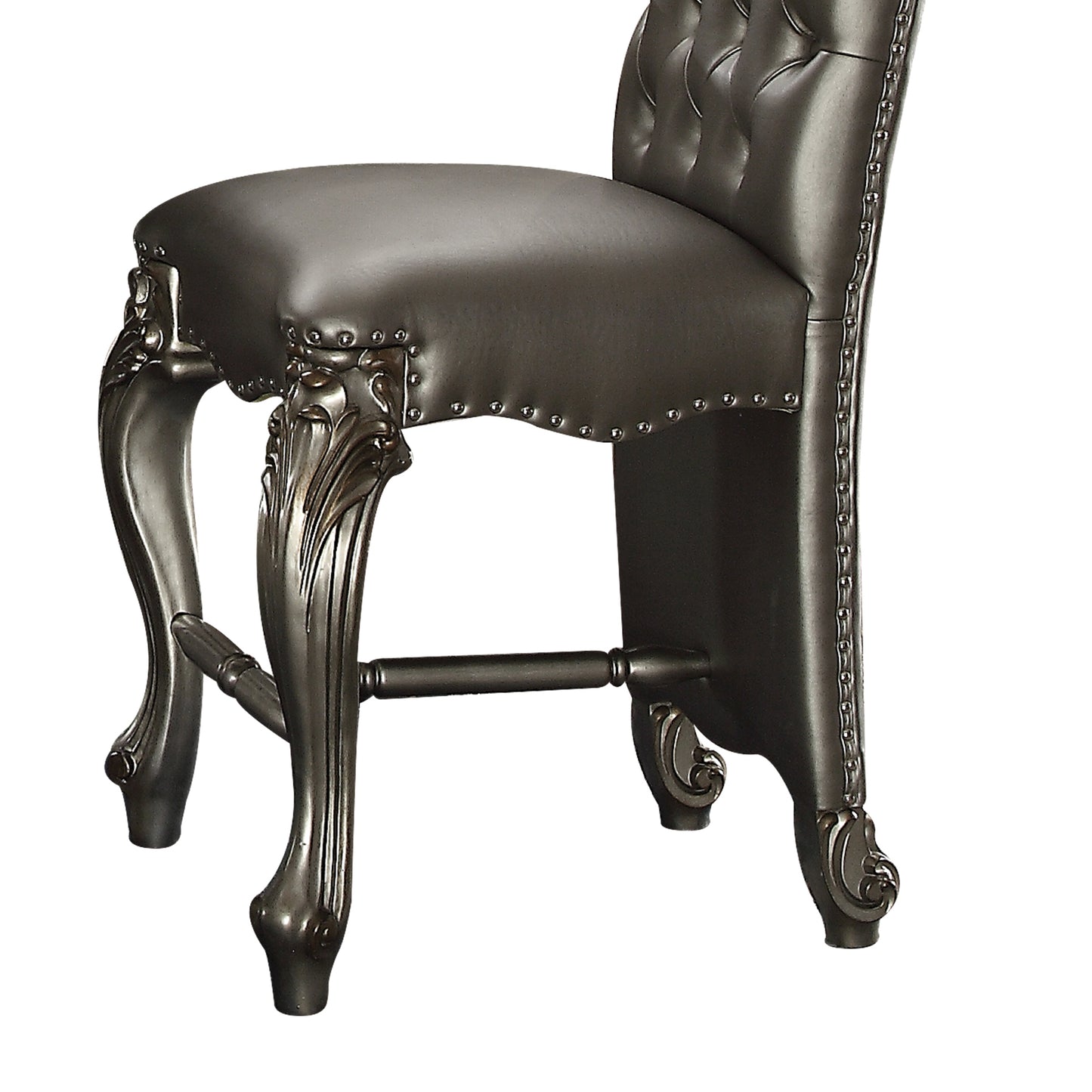 Dark gray tufted bar stool with ornate carved legs and silver nailhead trim