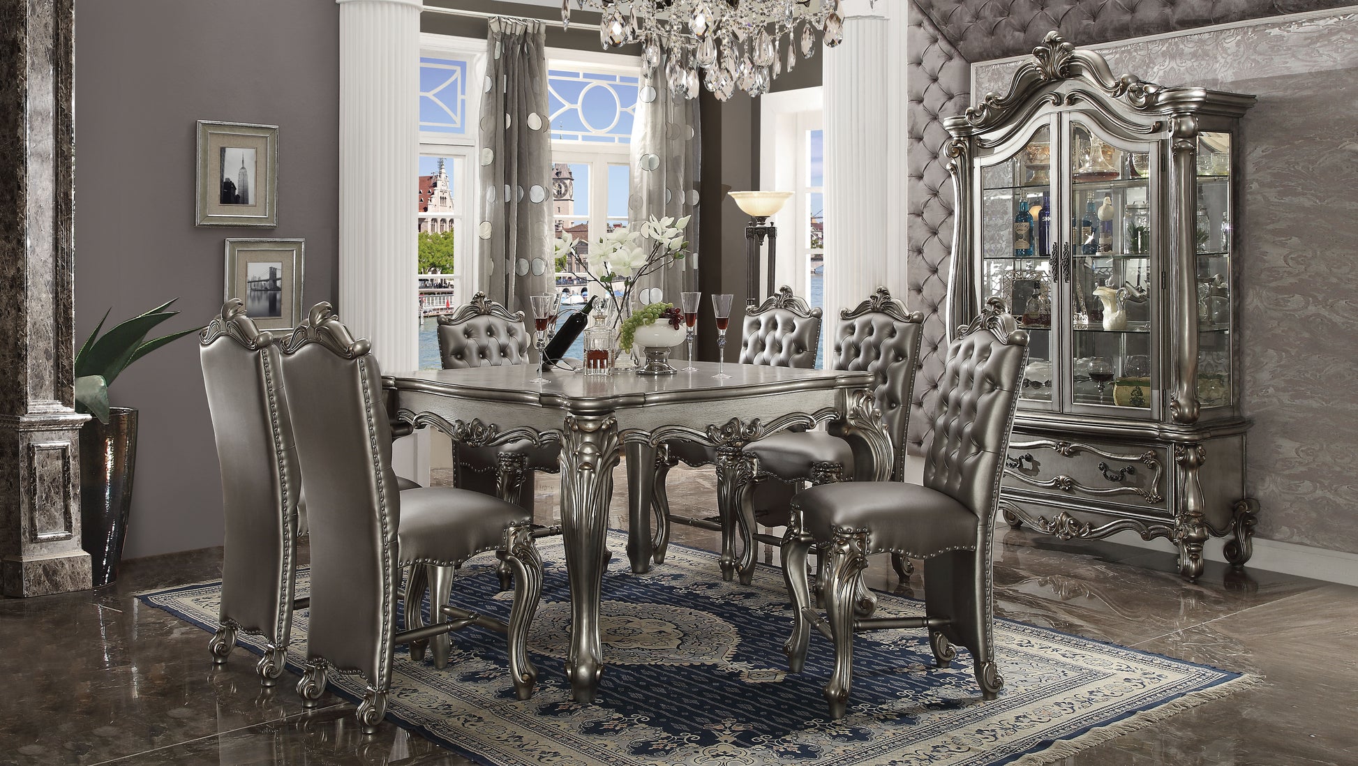 Elegant silver dining table with ornate carvings and six tufted chairs