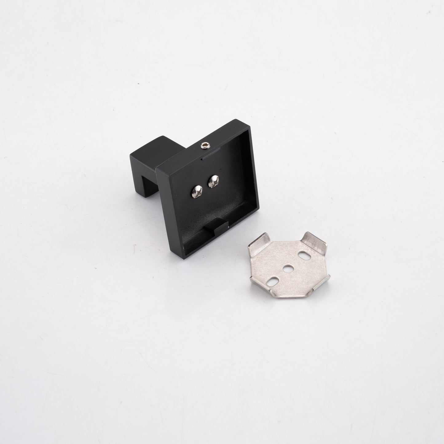Black metal shelf bracket with mounting screws and a small steel mounting plate