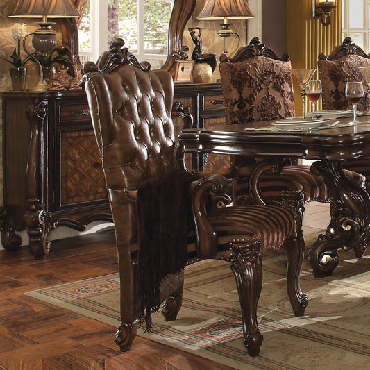Tufted brown leather armchair with ornate carved wood accents and a dark throw blanket