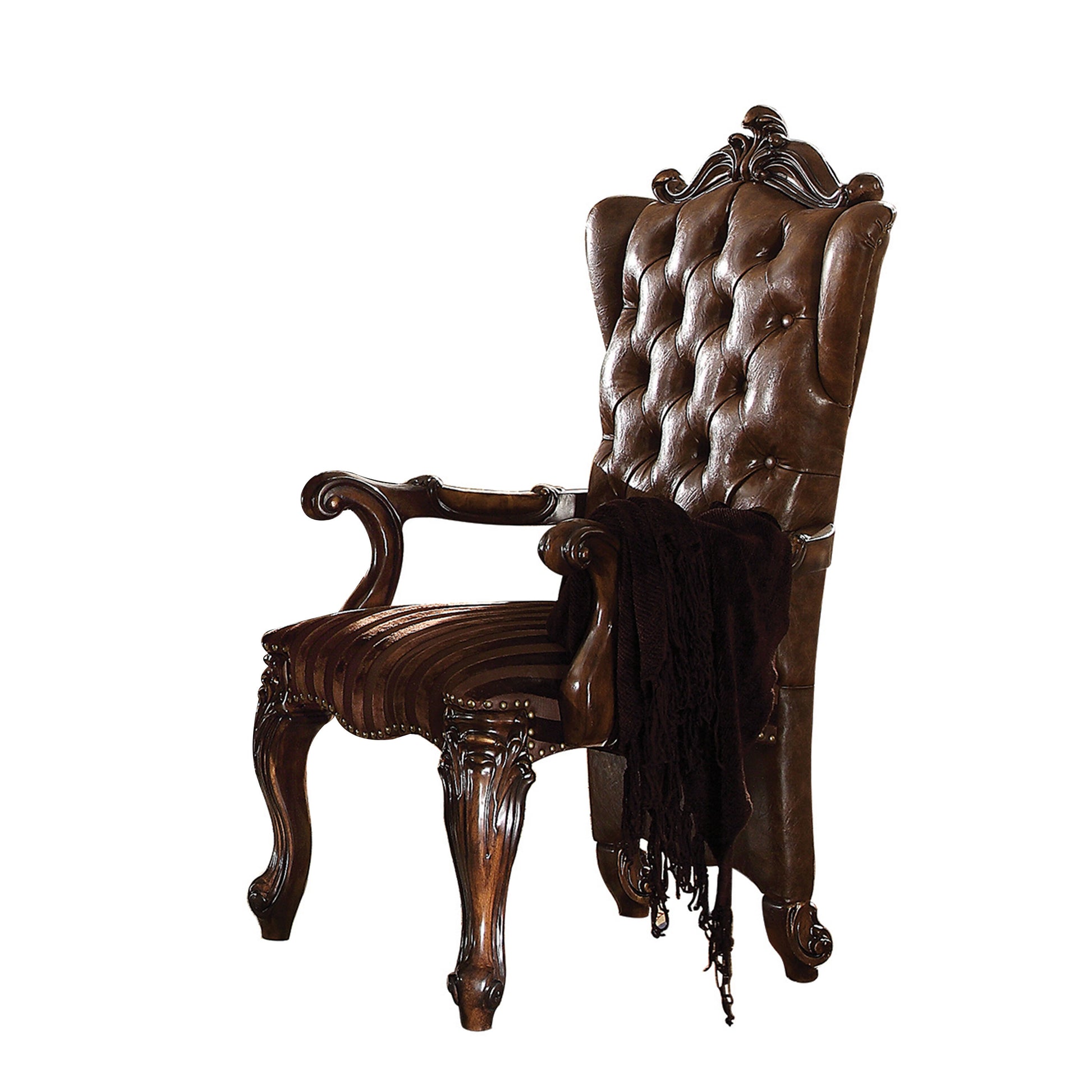 Ornate brown leather tufted accent chair with carved wood legs and a dark throw blanket