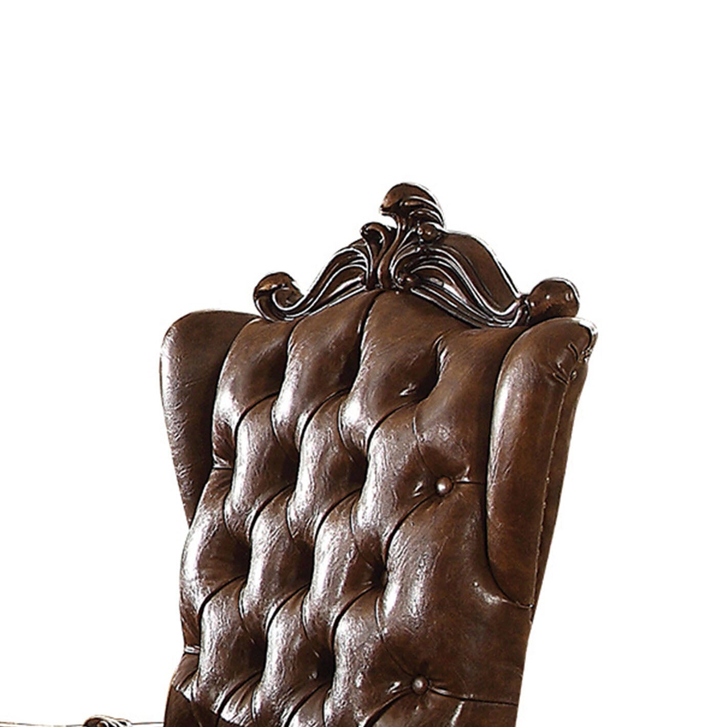 Tufted dark brown leather wingback chair detail with ornate carving