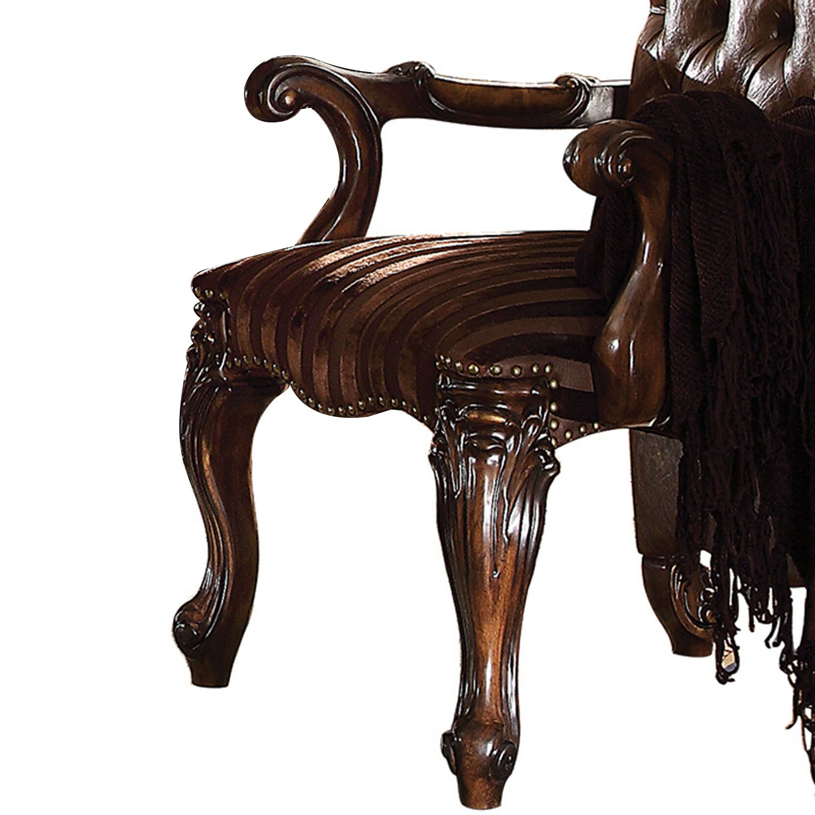 Ornate dark wood armchair with tufted upholstery and decorative carved legs