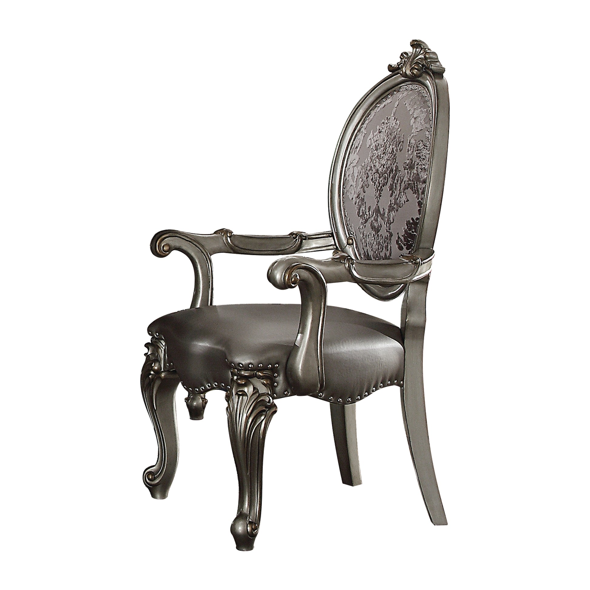 Ornate silver carved armchair with dark upholstered seat and detailed floral backrest