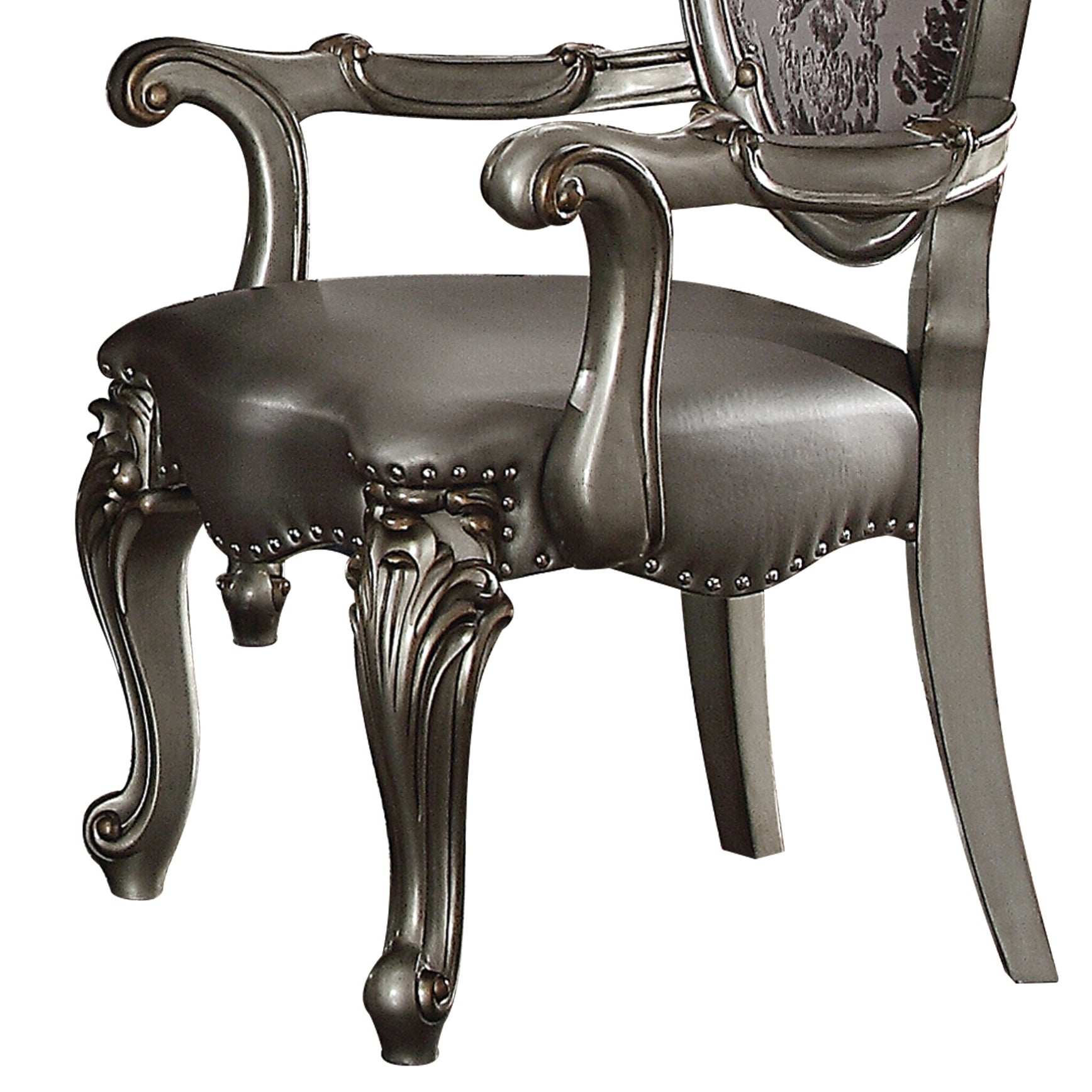 Ornate silver dining chair with faux leather seat and carved wooden legs