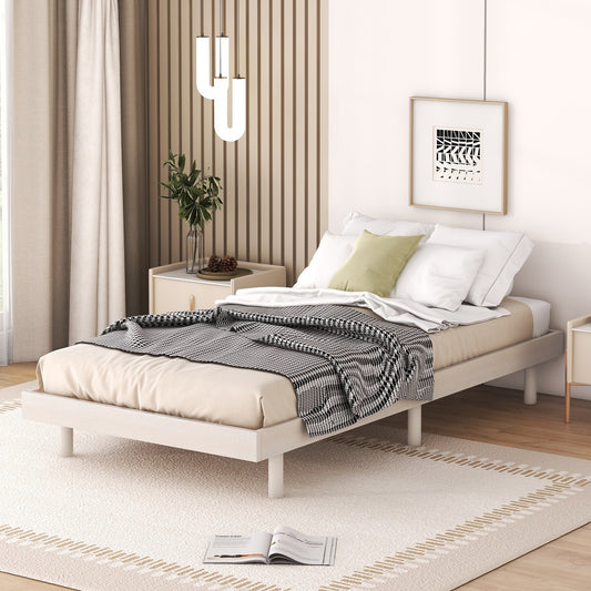 Light wood platform bed frame with white bedding and a black and white throw blanket