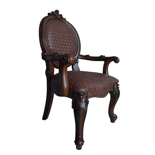 Antique armchair with dark brown tufted leather upholstery and ornate wooden frame
