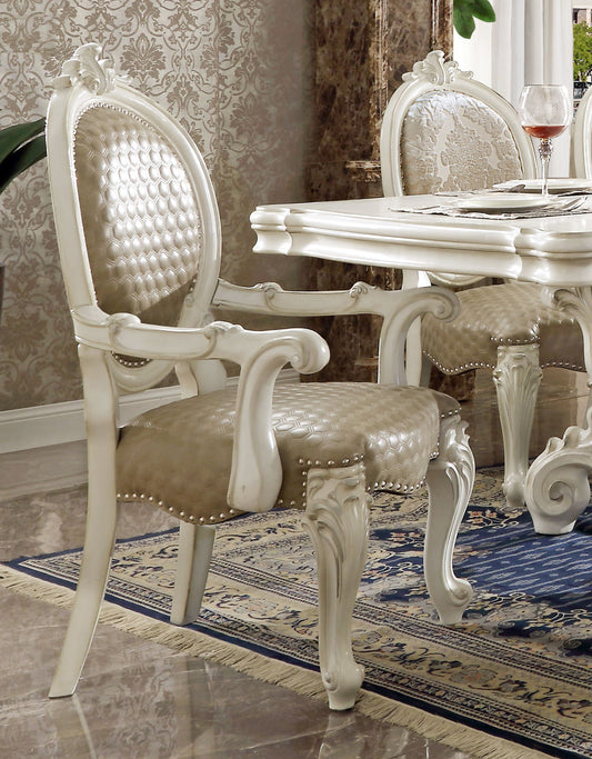 Ornate white dining chair with tufted taupe upholstered seat and back featuring carved detailing