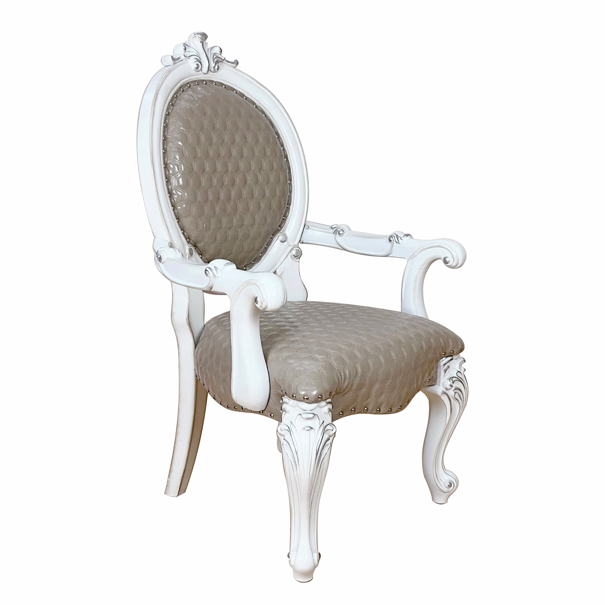 White carved armchair with taupe tufted upholstery and silver nailhead trim