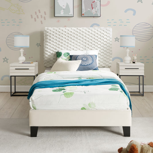 White textured toddler bed with green leaf print bedding and blue throw