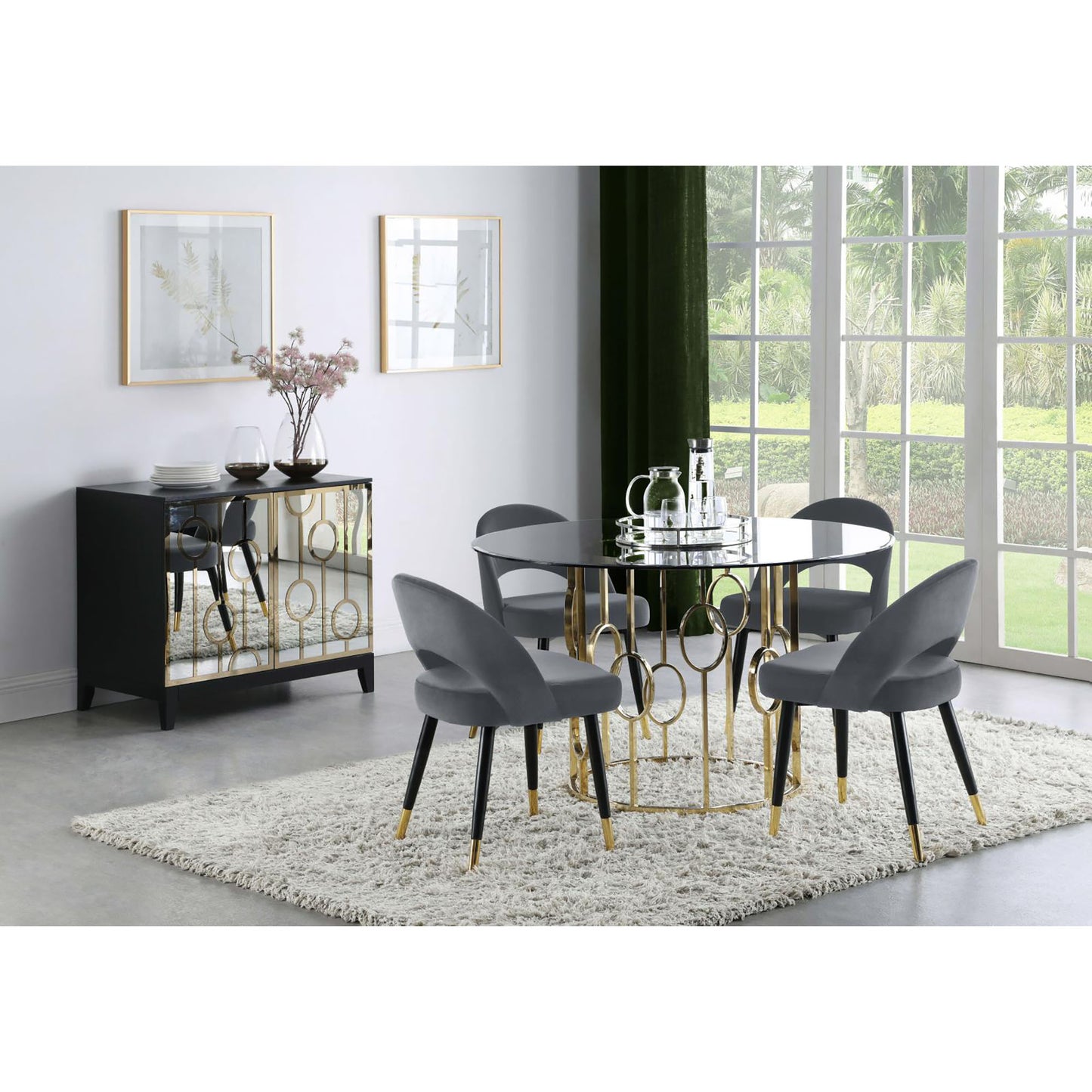 Modern grey velvet dining chairs with gold accents around a black glass table