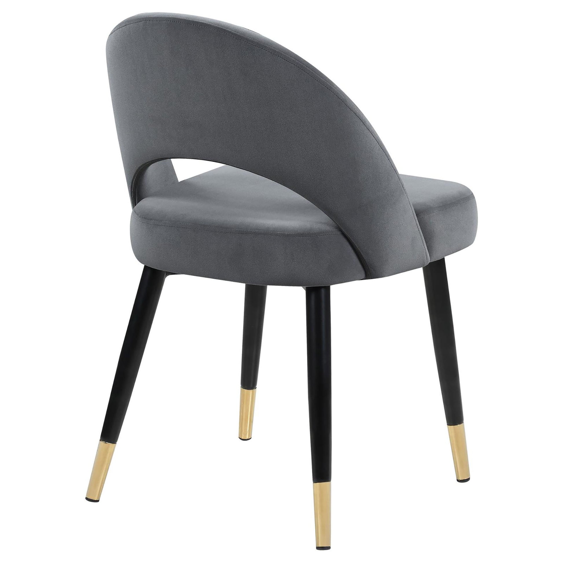 Modern gray velvet dining chair with sleek black legs and gold accents