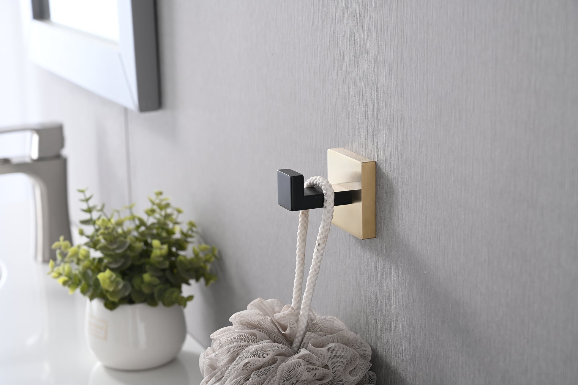 Modern brushed brass and black wall hook with a minimalist design perfect for bathrooms