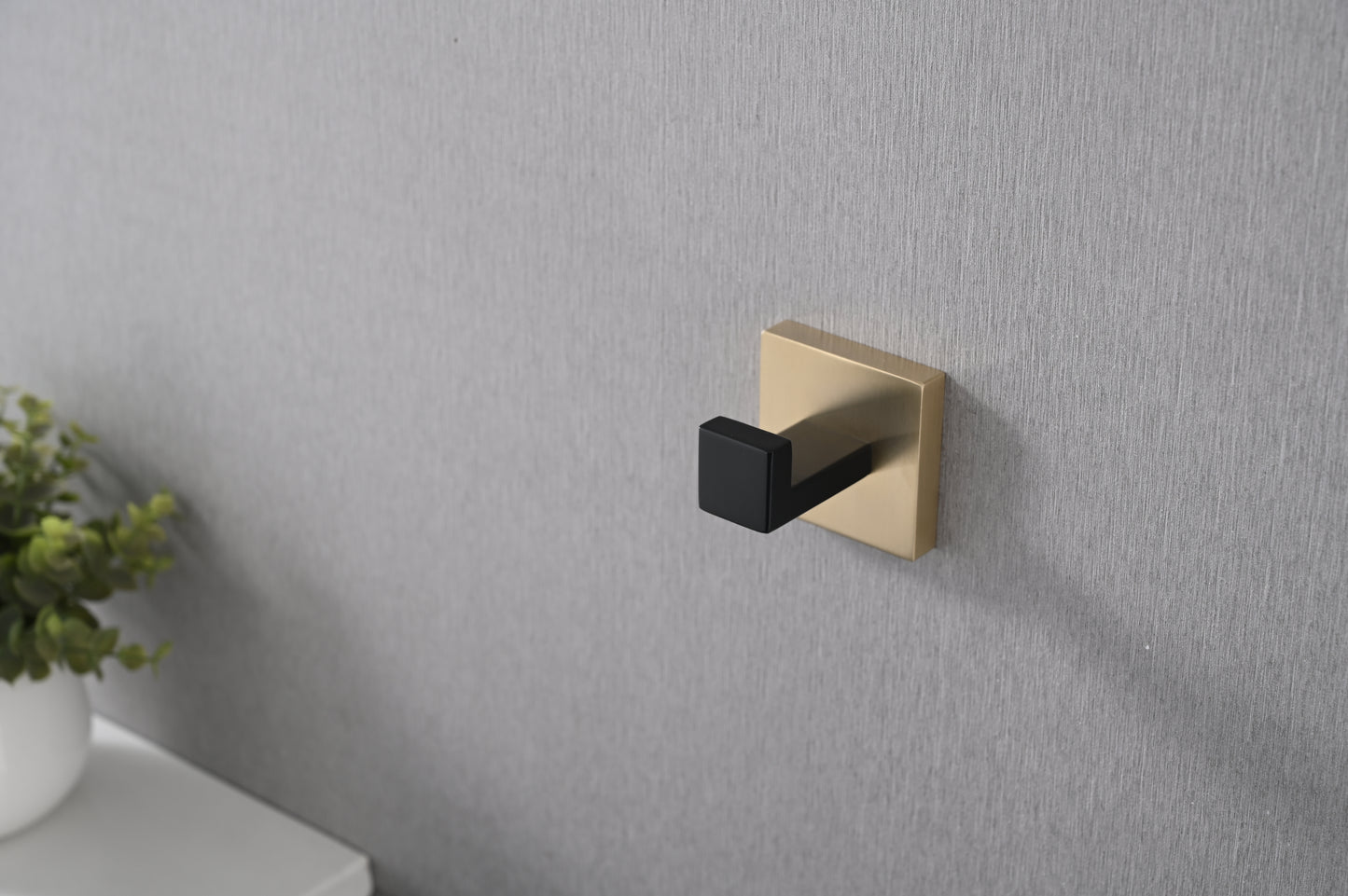 Modern brass wall hook with a black matte finish ideal for bathrooms