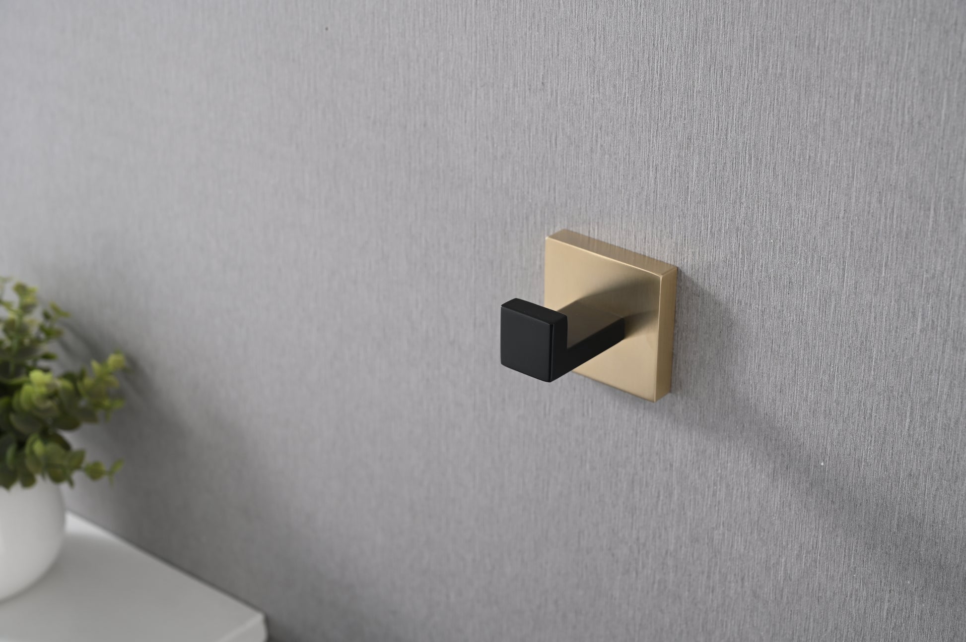Modern brass wall hook with a black matte finish ideal for bathrooms