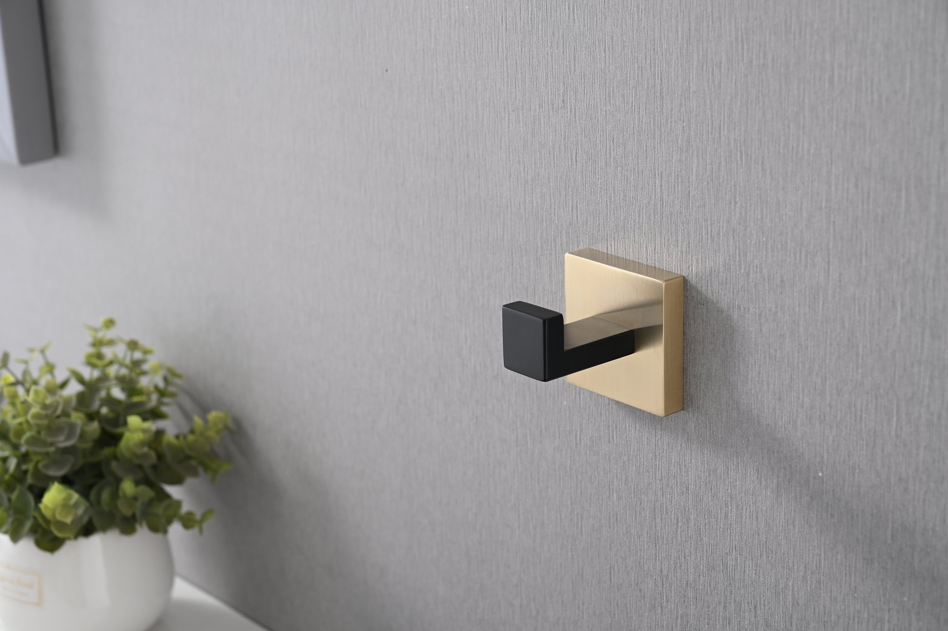 Modern matte black and brushed gold wall hook for entryway organization