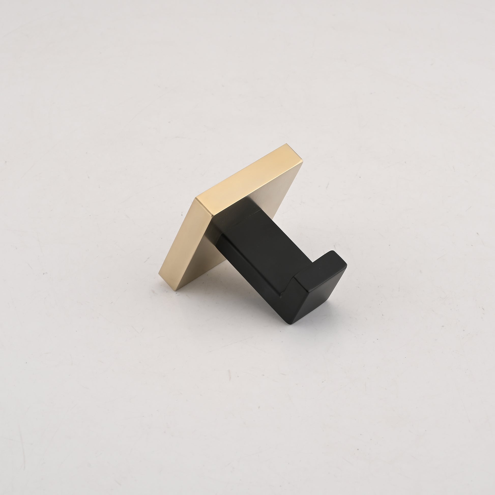 Modern brass and black wall hook with a sleek minimalist design