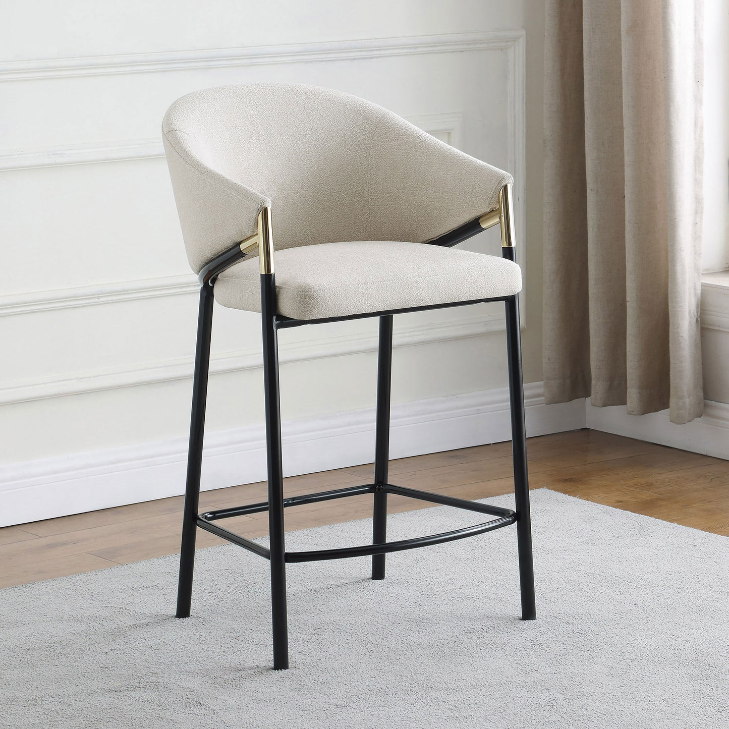 Textured cream boucle bar stool with gold accents and black metal legs