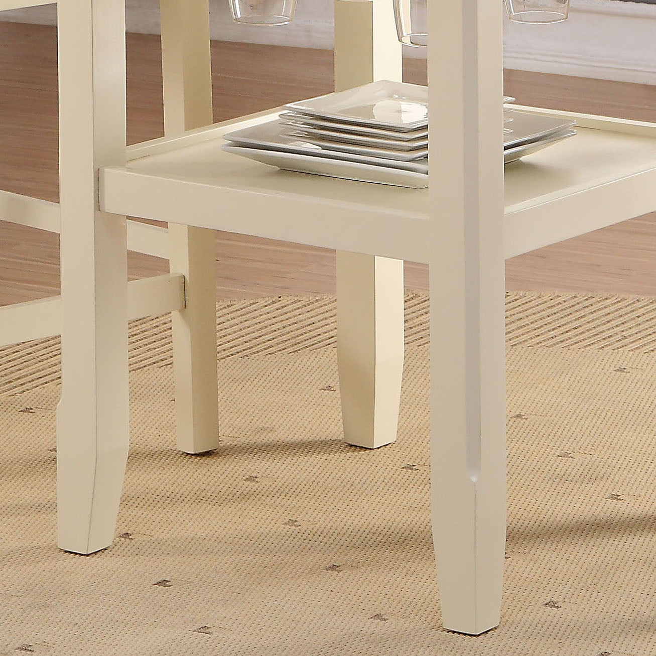 Creamcolored wooden dining chairs with square plates stacked on a builtin shelf