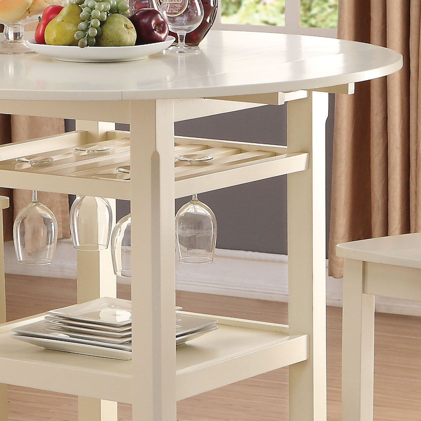 Creamcolored kitchen island with wine glass rack and plate storage