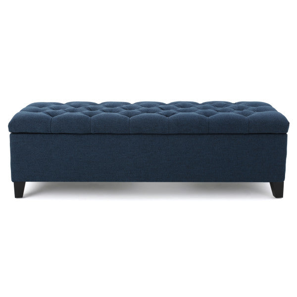 Navy blue upholstered storage ottoman with button tufting and dark legs