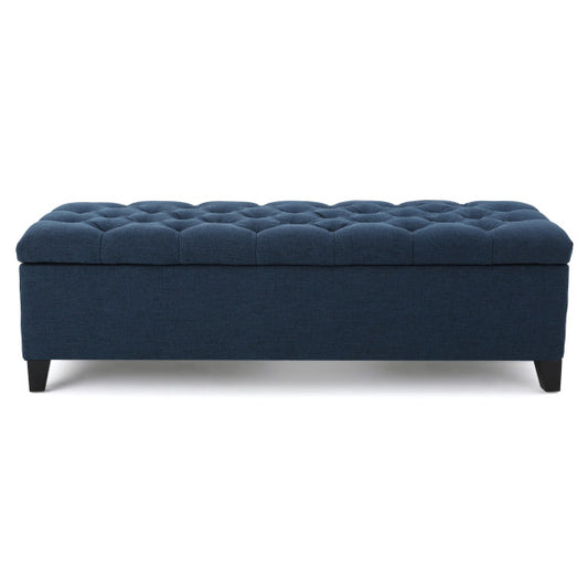 Navy blue upholstered storage ottoman with button tufting and dark legs