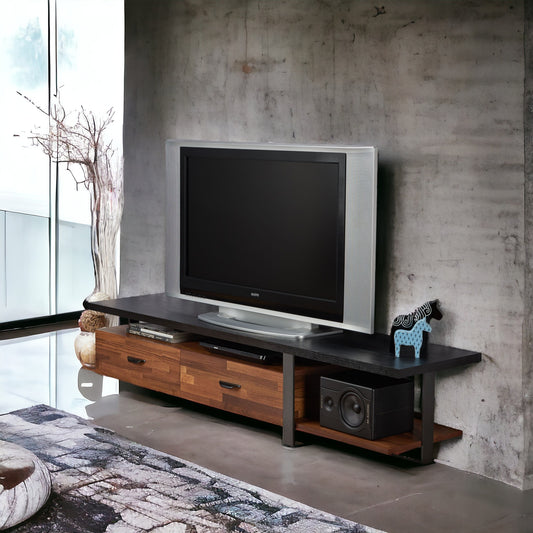 Modern walnut TV stand with drawers and media storage housing a flatscreen television