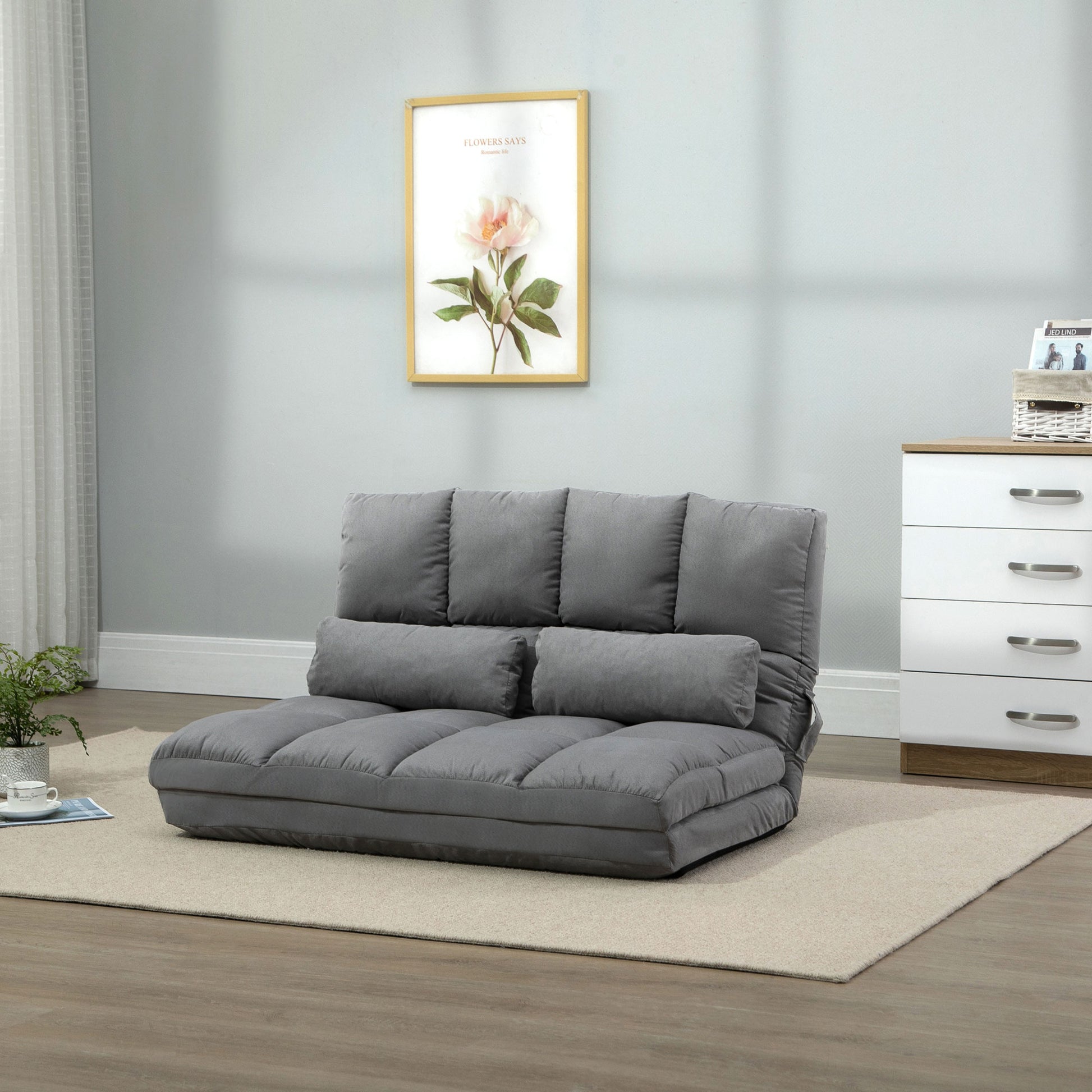 Gray fabric floor sofa with plush cushions and accent pillows perfect for small spaces