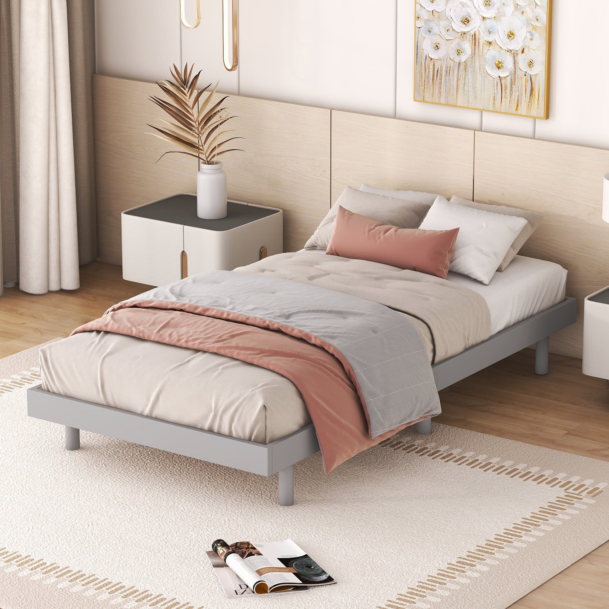 Grey metal twin bed with a blush pink throw and striped duvet