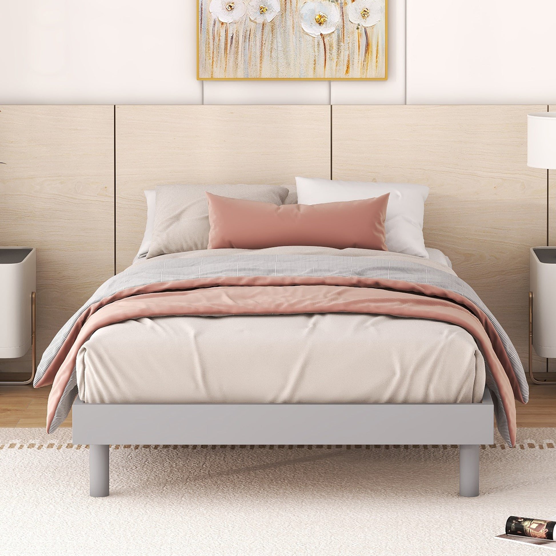 Modern gray metal bed frame with white and pink bedding