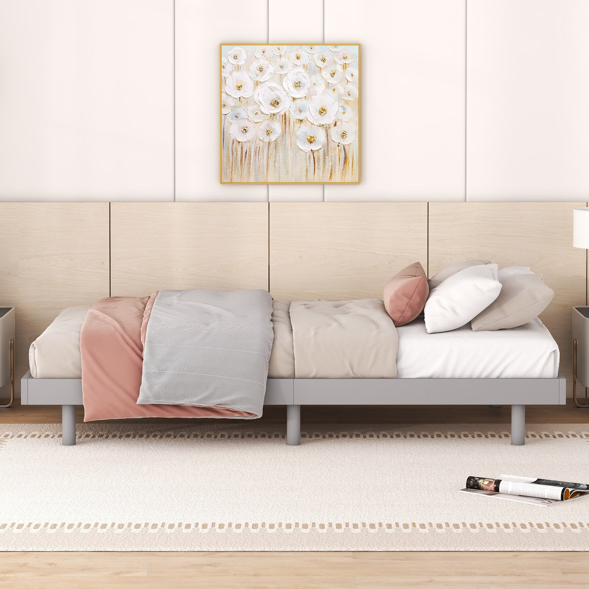Minimalist grey metal platform bed frame with white linens and blush pink throw